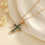 Elegant Gold Necklace Featuring a Majestic Emerald Cross Pendant