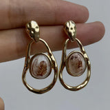 Unique Golden Earrings Featuring Asymmetrical White Stone