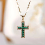 Elegant Gold Necklace Featuring a Majestic Emerald Cross Pendant